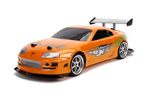 Jada Toys Fast & Furious RC Auto Drift 1995 Toyota Supra Turbo-Coche teledirigido con 2 Canales, función de Carga USB, 4 neumáticos de Repuesto, Incluye Pilas, 1:10, Color Naranja (253209003)