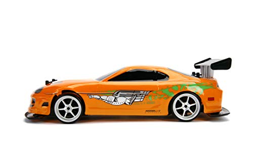 Jada Toys Fast & Furious RC Auto Drift 1995 Toyota Supra Turbo-Coche teledirigido con 2 Canales, función de Carga USB, 4 neumáticos de Repuesto, Incluye Pilas, 1:10, Color Naranja (253209003)